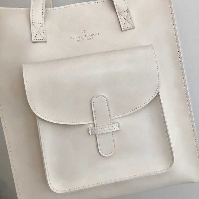 Close-up of front pocket and logo on off-white Vintage Soft Leather Convertible Bag at Grandmama Store in Hong Kong