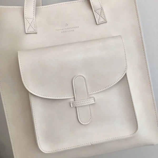 Close-up of front pocket and logo on off-white Vintage Soft Leather Convertible Bag at Grandmama Store in Hong Kong