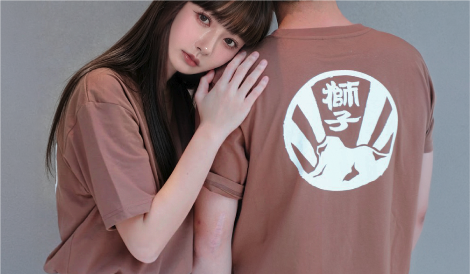 Couple wearing brown Kamon Tee-Lion Rock cotton T-shirts at Grandmama Store in Hong Kong