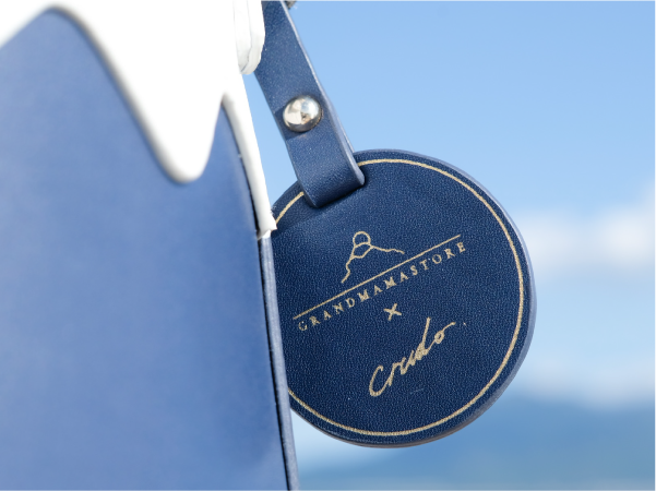 Custom engraved navy leather tag on the Mt. Fuji Goen Bag at Grandmama Store in Hong Kong