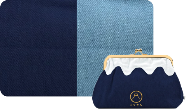 Flat lay view of the dark blue denim Mt. Fuji Pocket Bag with denim fabric swatch background at Grandmama Store in Hong Kong.