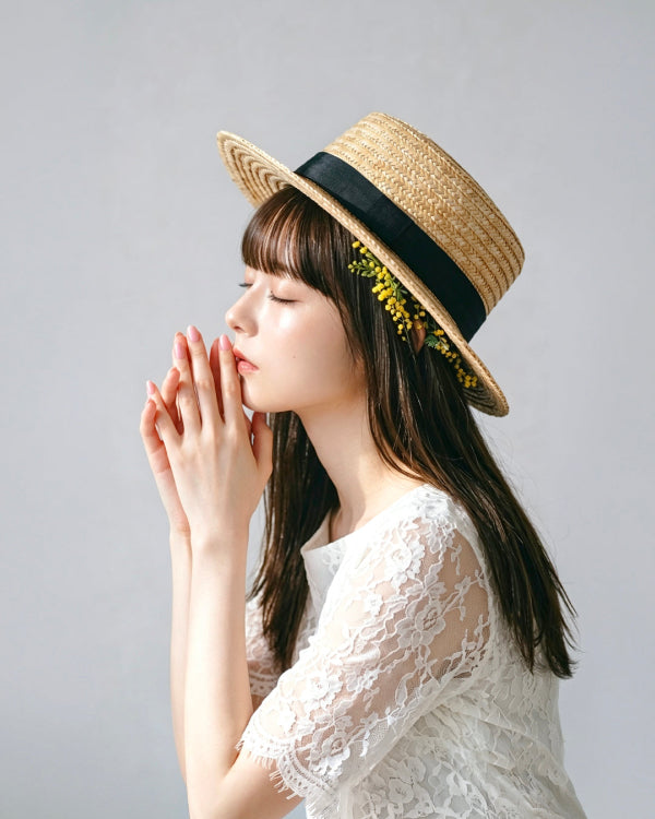 French Straw Boater Hat with black ribbon band and yellow flower detail at Grandmama Store in Hong Kong