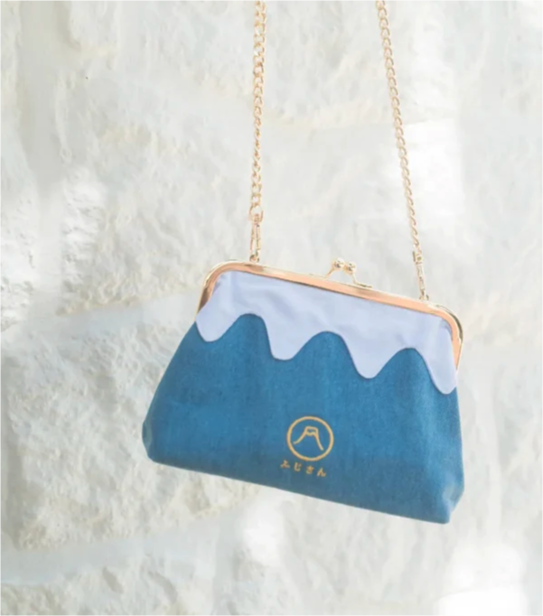 Full shot of the light blue denim Mt. Fuji Pocket Bag with gold chain strap at Grandmama Store in Hong Kong.