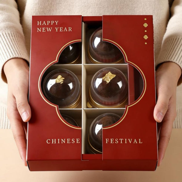 Hands holding a red Chinese New Year gift box of Dubai Chocolate Chewy at Grandmama Store in Hong Kong