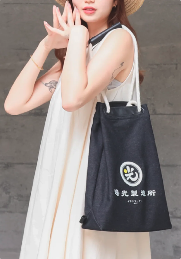 Light of Dawn Sake Bag Black Denim female model shoulder bag photo at Grandmama Store in Hong Kong.