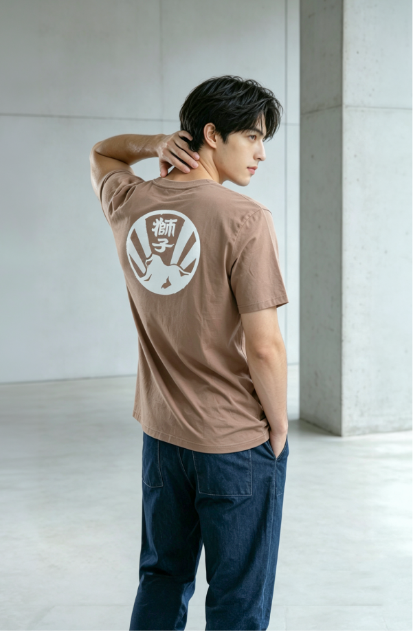 Male model wearing brown Kamon Tee-Lion Rock graphic T-shirt at Grandmama Store in Hong Kong