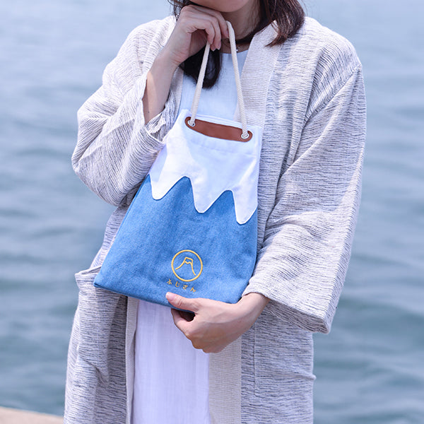 Model carrying Medium Light Blue Mt. Fuji Sake Bag outdoors at Grandmama Store in Hong Kong