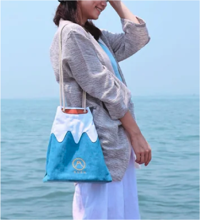 Model carrying the Mt. Fuji Sake Bag in Light Blue on her shoulder at Grandmama Store in Hong Kong