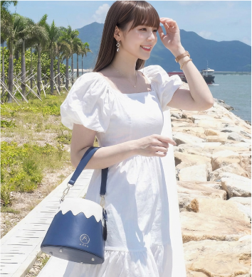 Model hand-carrying the dark navy Mt. Fuji Goen Bag as a handbag at Grandmama Store in Hong Kong