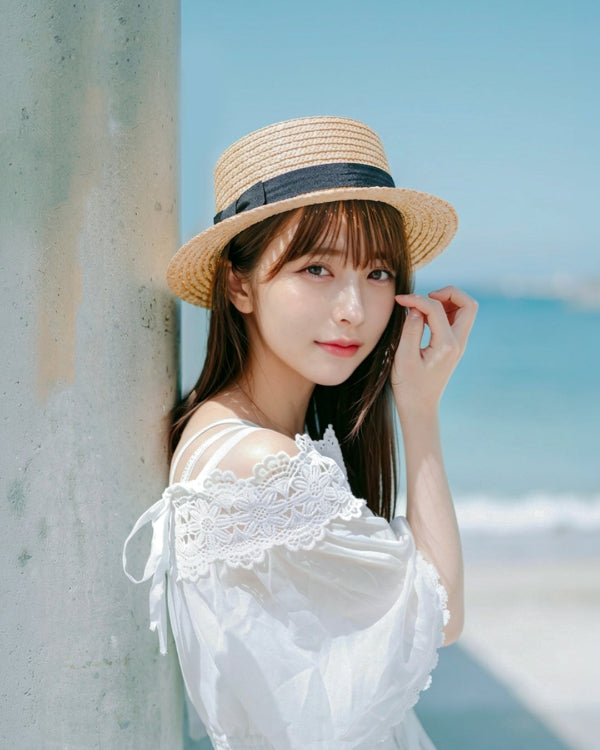 Model leaning near the beach wearing a French Straw Boater Hat at Grandmama Store in Hong Kong
