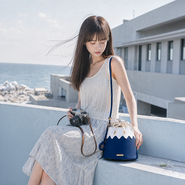 Model sitting outdoors with Mt. Fuji Goen Bag in Night navy at Grandmama Store in Hong Kong