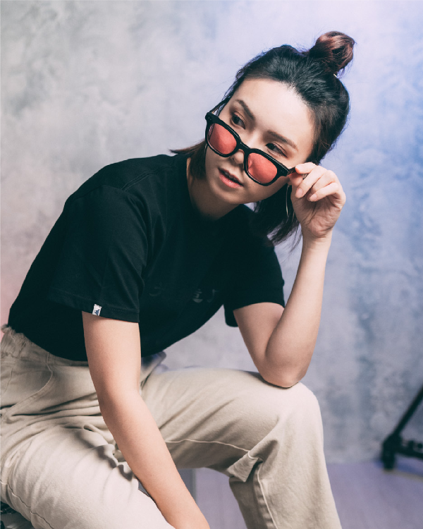 Model wearing Life Matters Black Cotton Tee Light of Dawn with sunglasses at Grandmama Store in Hong Kong