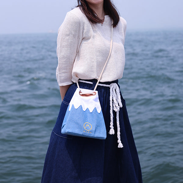 Model wearing Light Blue Mt. Fuji Sake Bag cross-body at Grandmama Store in Hong Kong