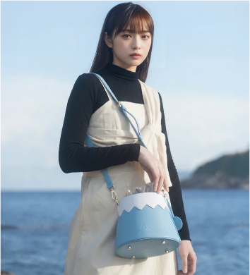 Model wearing Mt. Fuji Goen Bag in Light Blue as a shoulder bag at Grandmama Store in Hong Kong