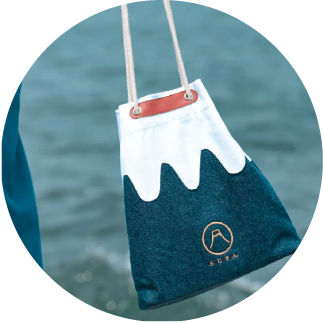 Mt. Fuji Sake Bag in Navy Blue held by drawstring handles at Grandmama Store in Hong Kong