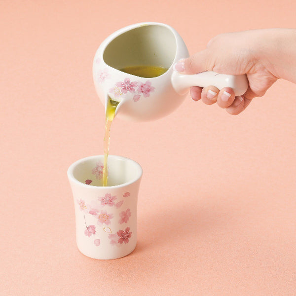 Pouring green tea from the Sakura Elegance Teapot into a matching teacup at Grandmama Store in Hong Kong