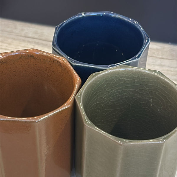 Three Nine‑Sided Japanese Tea Cups in brown, green, and blue at Grandmama Store in Hong Kong