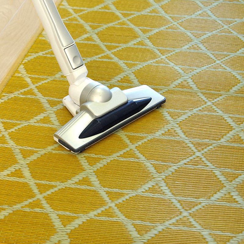 Vacuum cleaning the yellow IGUSA Rush Grass Floor Mat (Kyukawa Series) at Grandmama Store in Hong Kong
