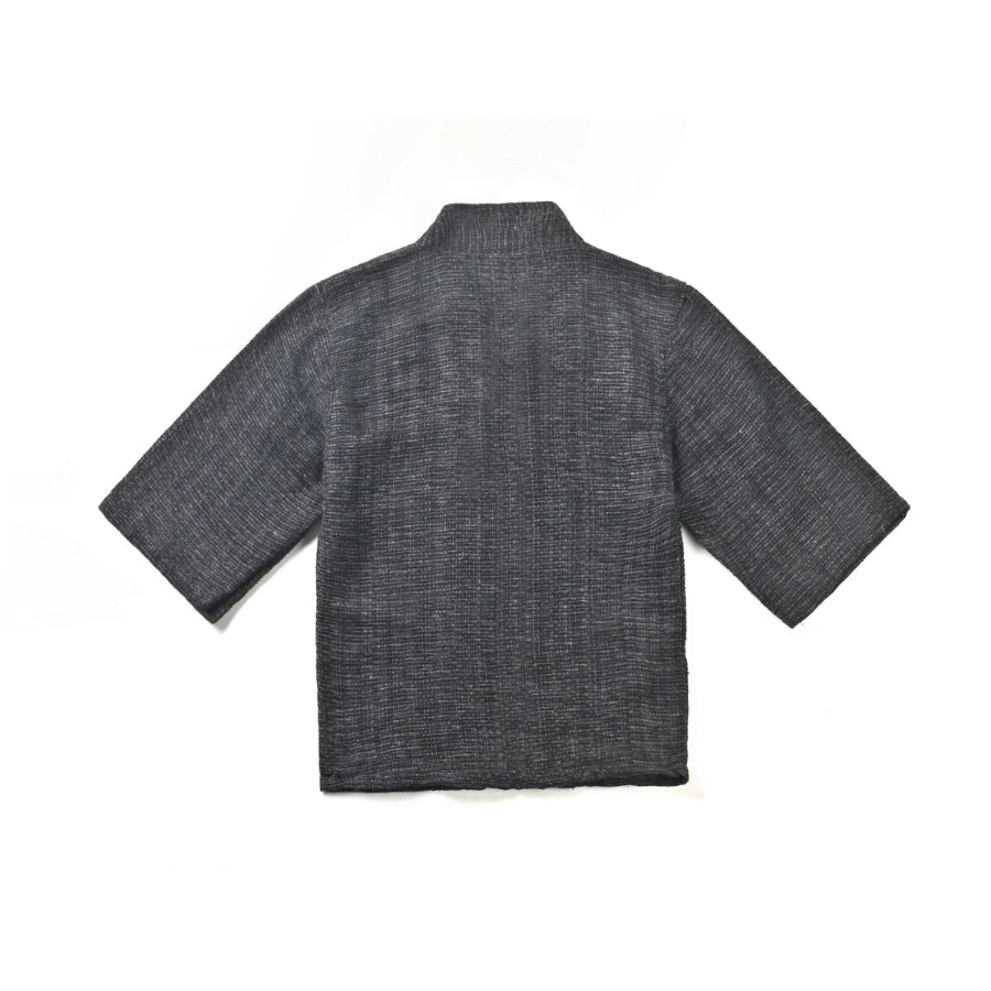 The back view of a hand-cranked Kimono jacket in Miho Matsubara color showing the textured charcoal gray handwoven fabric at Grandmama Store in Hong Kong.