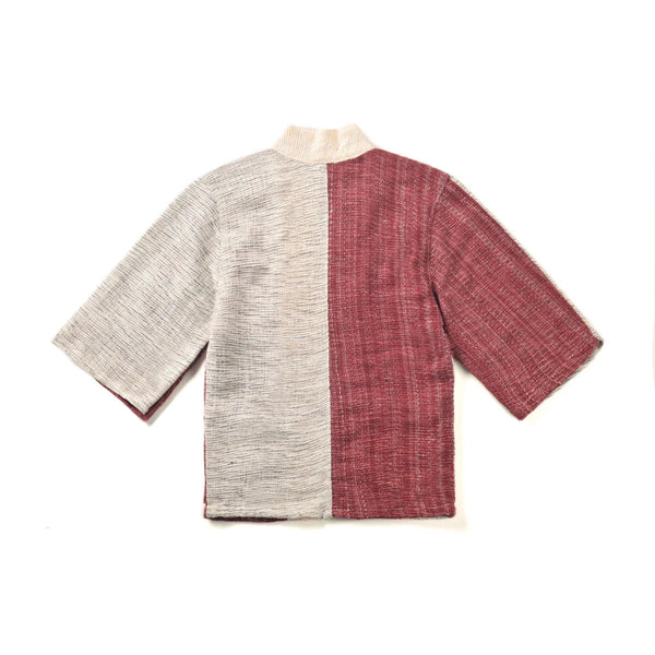 The back view of a panel-design hand-cranked Kimono jacket in Tokyo Tower color showing the textured light gray and dusty-red split fabric at Grandmama Store in Hong Kong.