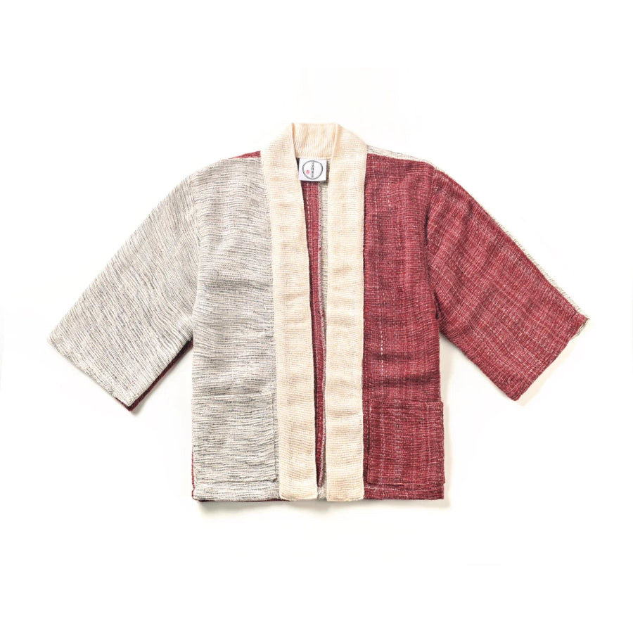A flat lay image of a panel-design hand-cranked Kimono jacket in Tokyo Tower color featuring textured light gray, dusty-red, and cream-white handwoven cotton fabrics at Grandmama Store in Hong Kong.