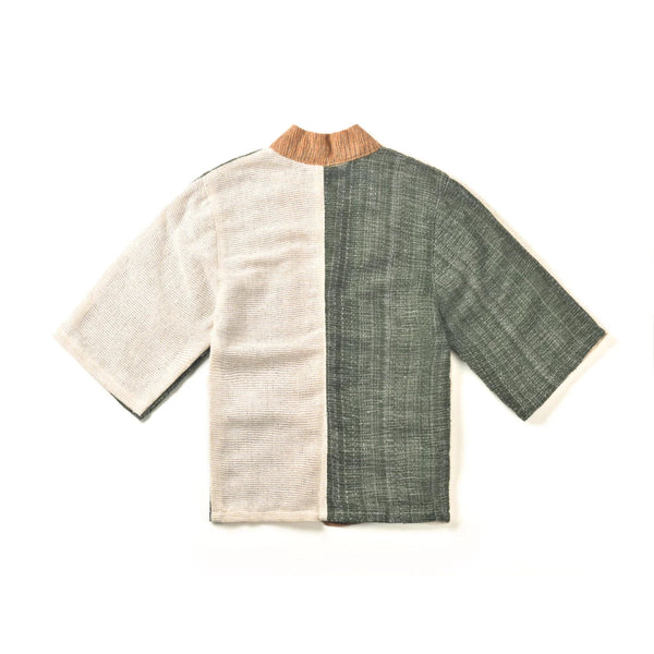 The back view of a panel-design hand-cranked Kimono jacket in Yakushima color showing the textured cream-beige and forest green split fabric at Grandmama Store in Hong Kong.